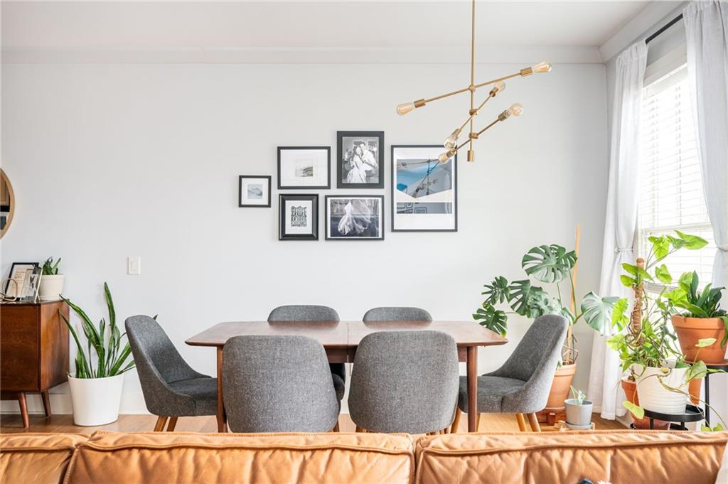 1628 Briarcliff Road Northeast, Unit 9 Atlanta, GA 30306 - Photo 13 of 25 a view of a dining room with furniture a potted plant and wooden floor