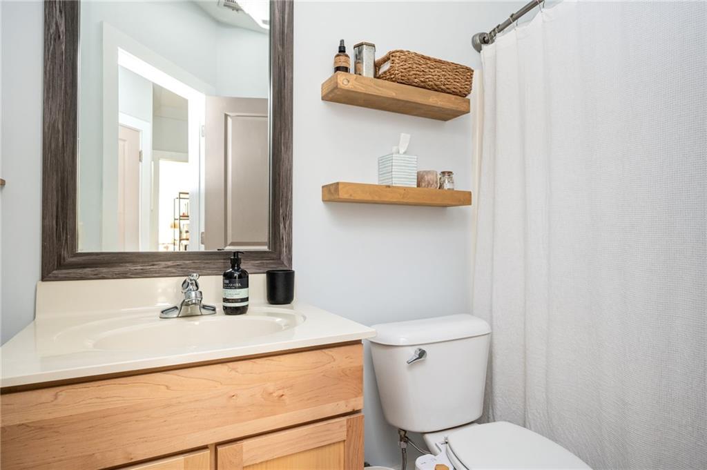 1628 Briarcliff Road Northeast, Unit 9 Atlanta, GA 30306 - Photo 16 of 25 a bathroom with a sink a toilet and a mirror