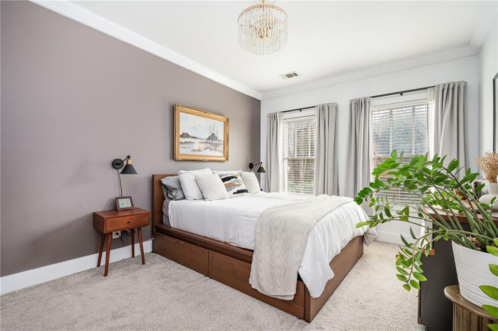 1628 Briarcliff Road Northeast, Unit 9 Atlanta, GA 30306 - Photo 17 of 25 a bedroom with a bed and a chandelier