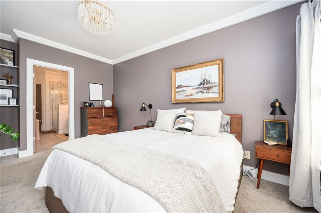 1628 Briarcliff Road Northeast, Unit 9 Atlanta, GA 30306 - Photo 18 of 25 a bedroom with a bed and a chandelier
