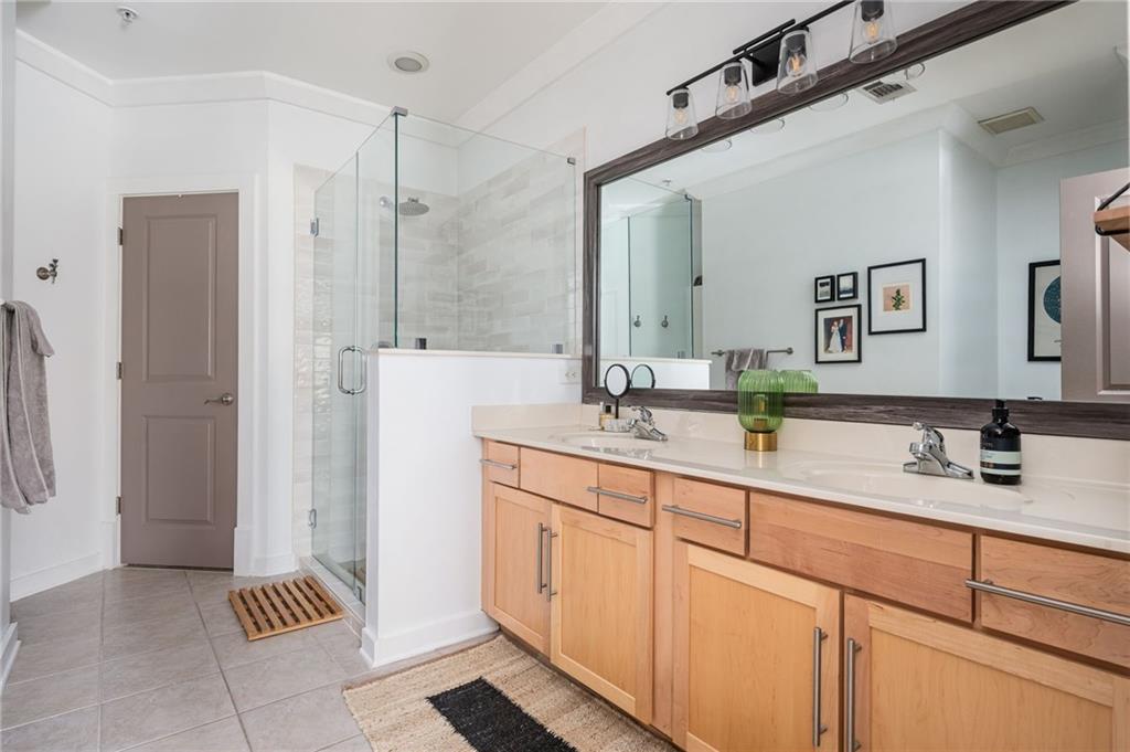 1628 Briarcliff Road Northeast, Unit 9 Atlanta, GA 30306 - Photo 19 of 25 a bathroom with a double vanity sink a and mirror