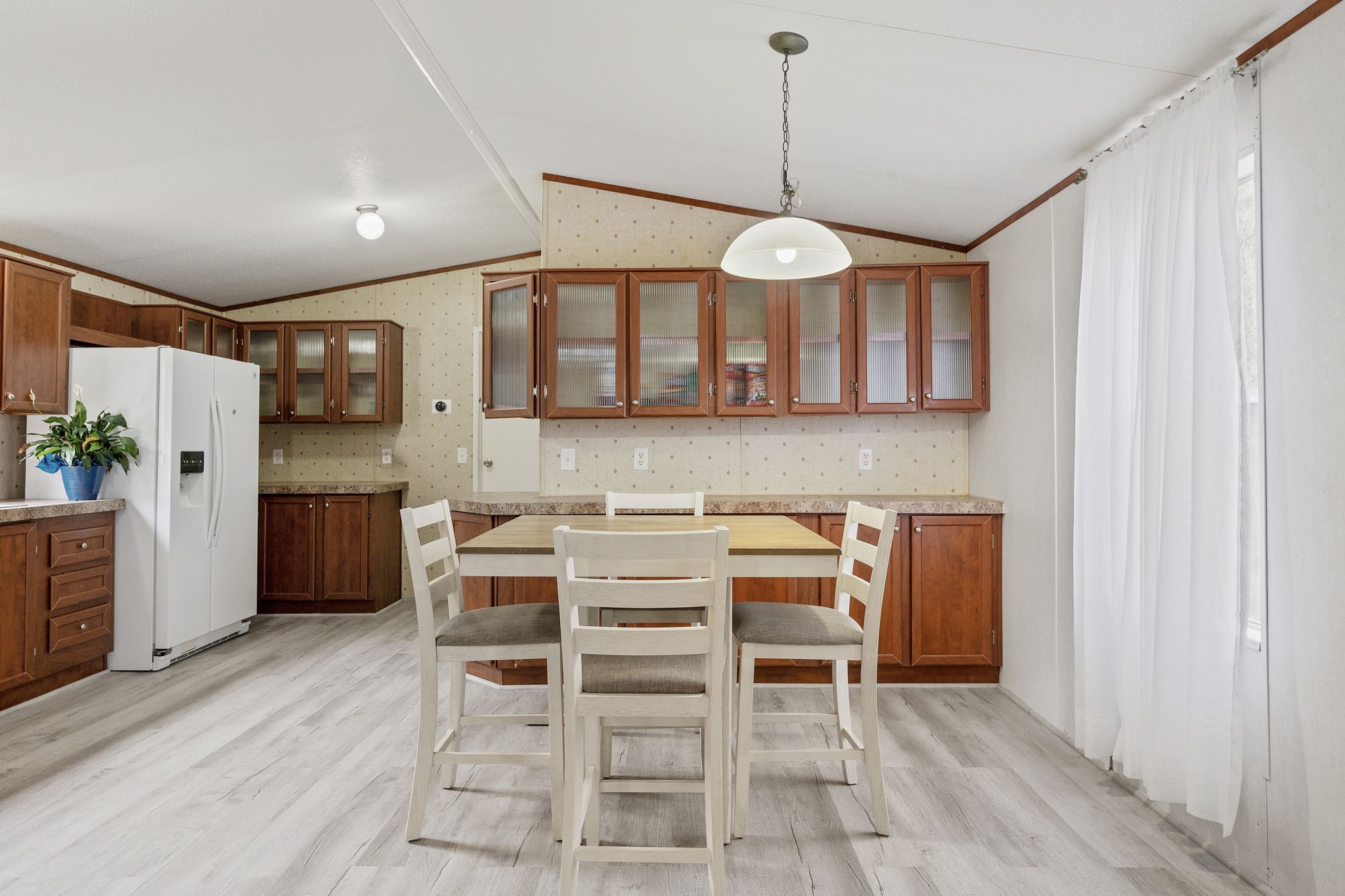 6493 Pappas Road Waller, TX 77484 - Photo 10 of 28 Dedicated dining space centered within the home, offering natural light and proximity to the kitchen.
A practical anchor point for everyday meals or hosting.