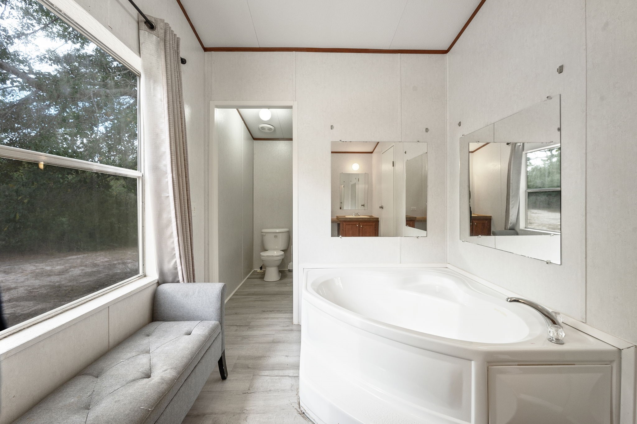 6493 Pappas Road Waller, TX 77484 - Photo 17 of 28 Deep soaking tub in primary bath, the perfect retreat for relaxation after a day at the nearby industrial hubs.