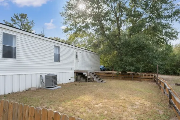 a backyard of a house with table and chairs