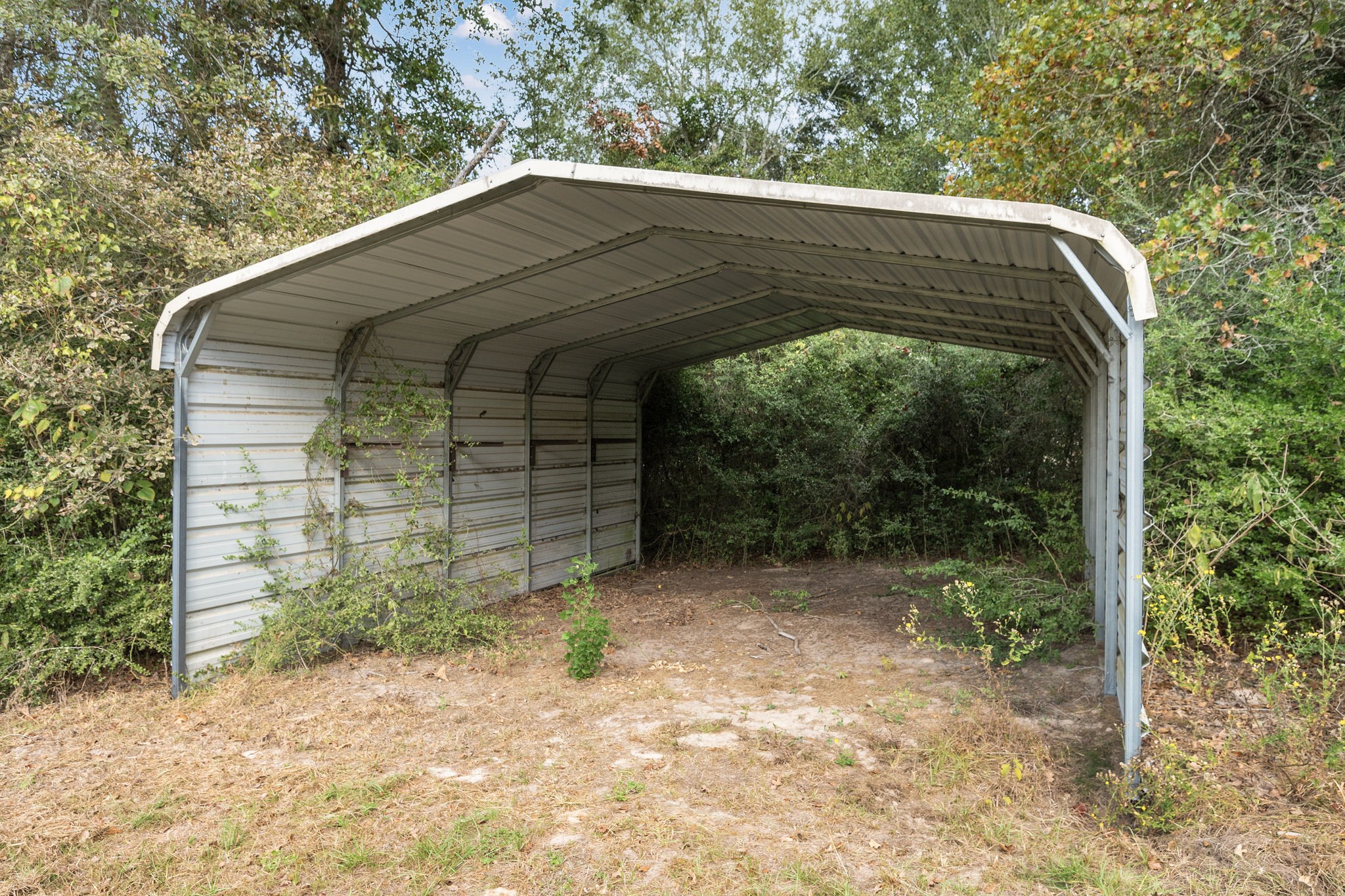 6493 Pappas Road Waller, TX 77484 - Photo 23 of 28 Interior view of RV cover showing generous height clearance for trailers and recreational vehicles.