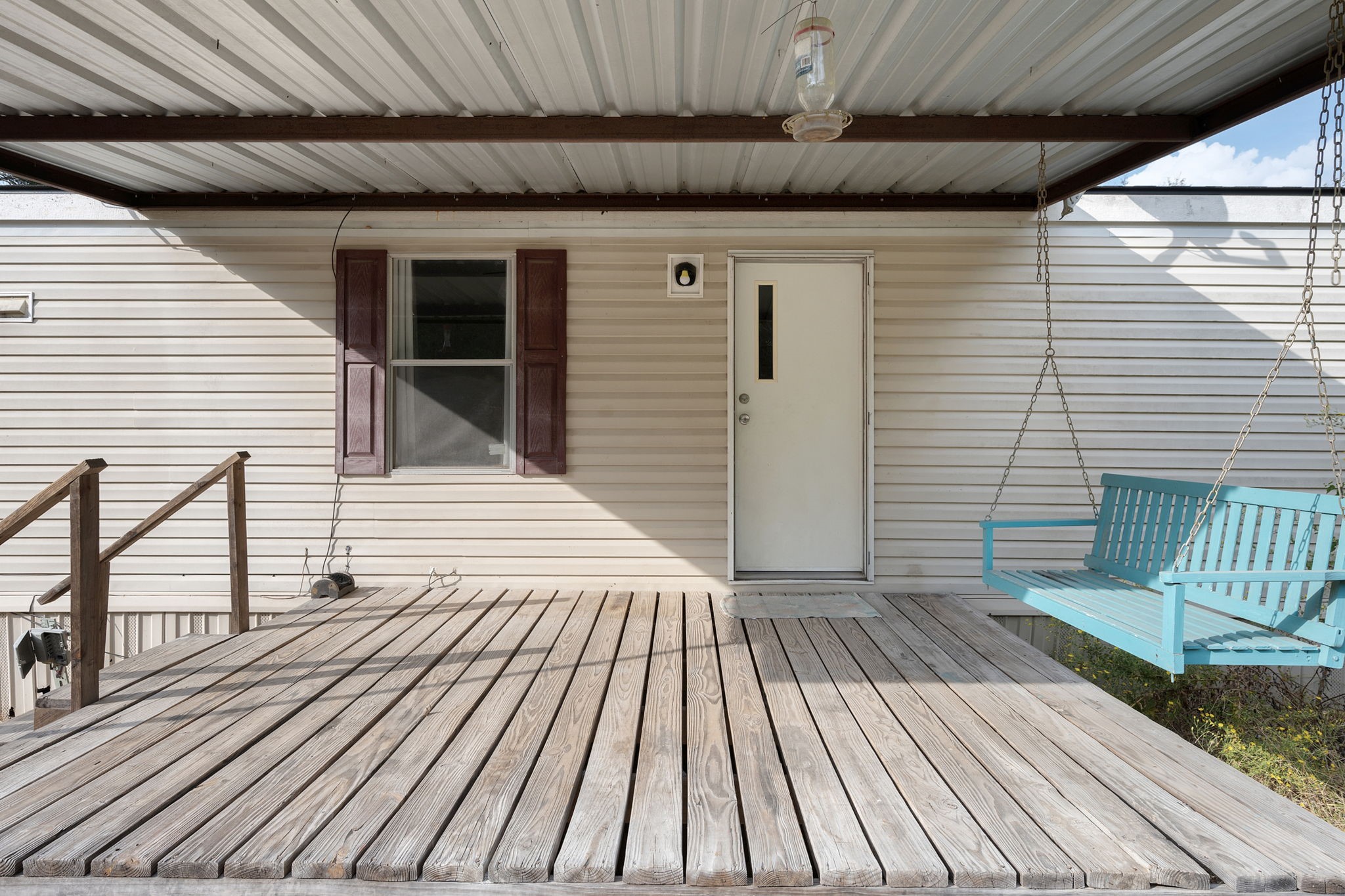 6493 Pappas Road Waller, TX 77484 - Photo 7 of 28 Covered front porch with swing, capturing the quintessential "Texas Forest" lifestyle in a quiet Grimes County setting.