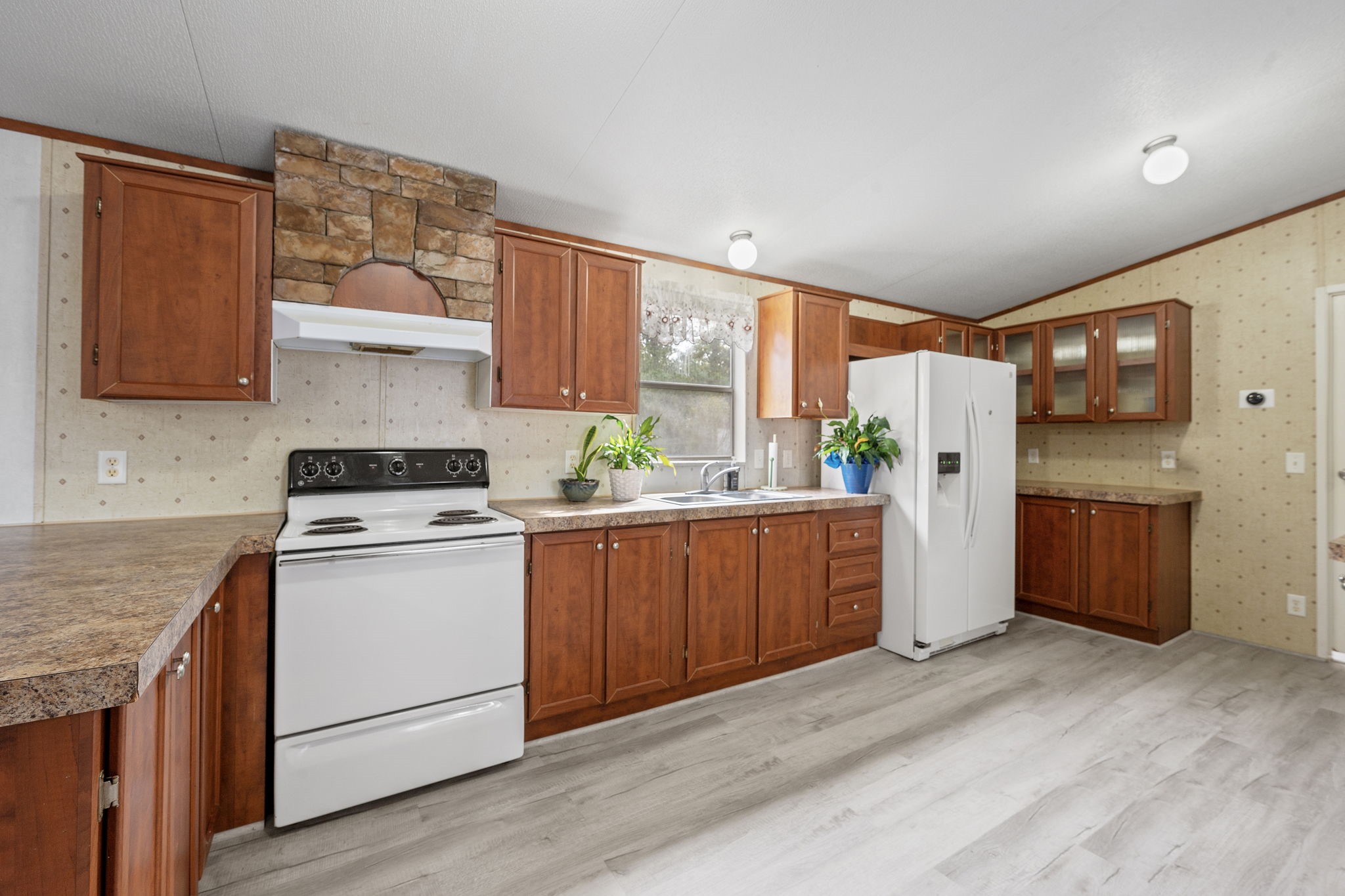 6493 Pappas Road Waller, TX 77484 - Photo 8 of 28 Functional kitchen with generous cabinetry, ample counter space, and direct connection to the main living area.
Well-suited for everyday use or future customization, with clear sightlines throughout.