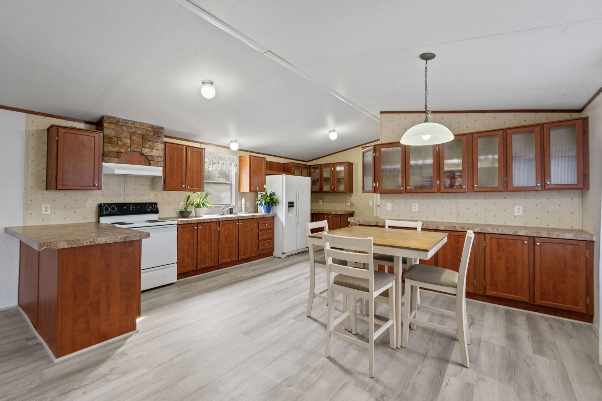 6493 Pappas Road Waller, TX 77484 - Photo 9 of 28 Functional kitchen with ample cabinet storage and views into the living area—ideal for the "290 corridor" professional with open-flow layout, perfect for preparing meals while staying connected to family activities.
