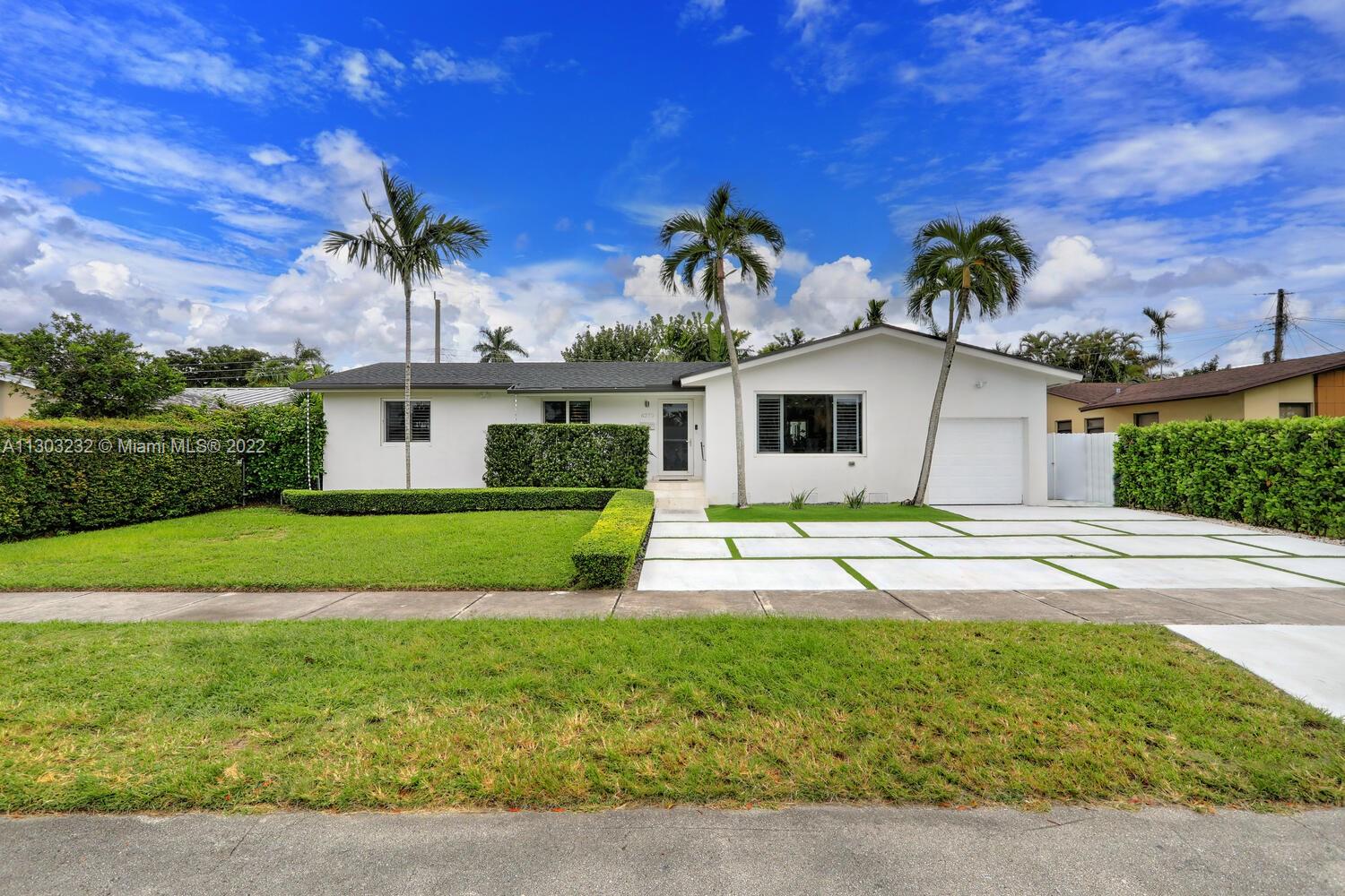 a front view of house with yard and outdoor seating