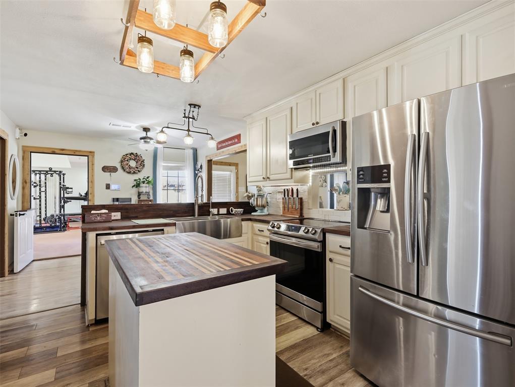 3823 State Highway Bonham, TX 75418 - Photo 8 of 37 a kitchen with stainless steel appliances granite countertop a refrigerator a stove and a sink