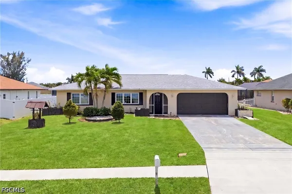 a front view of house with yard and outdoor seating