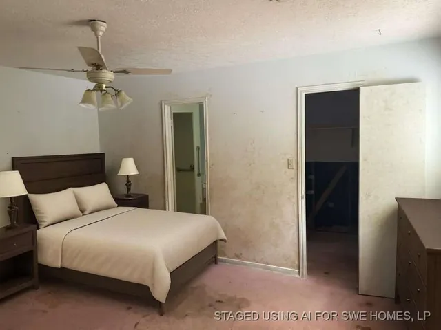 a bedroom with a bed and a ceiling fan