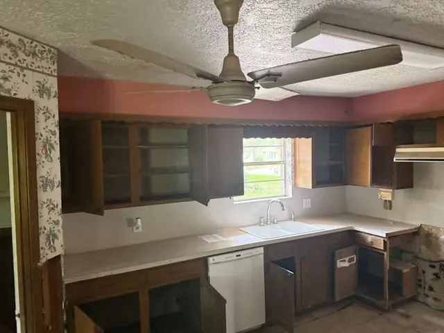 a kitchen with a sink and a stove top oven