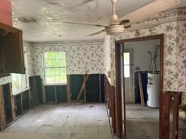 a view of empty room with a fireplace and windows