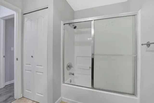 a bathroom with a glass shower door