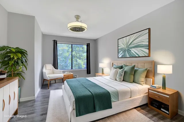 a bedroom with bed and a large window