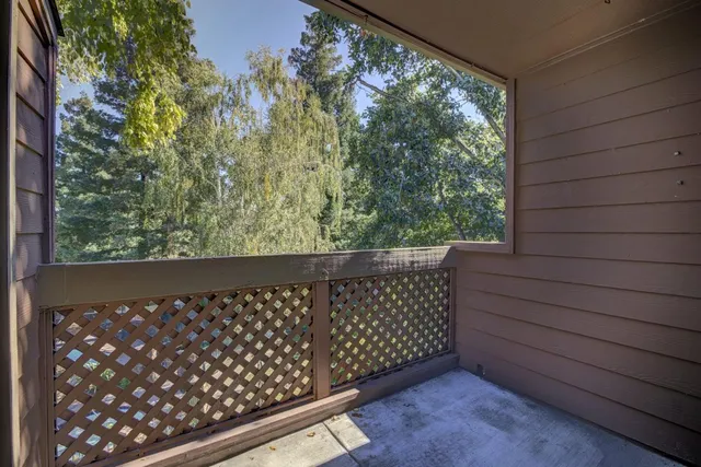 a wooden bench sitting in front of a building
