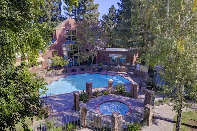 an aerial view of a house with yard swimming pool and outdoor seating