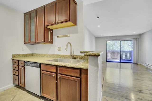 a kitchen with a sink a cabinets and window