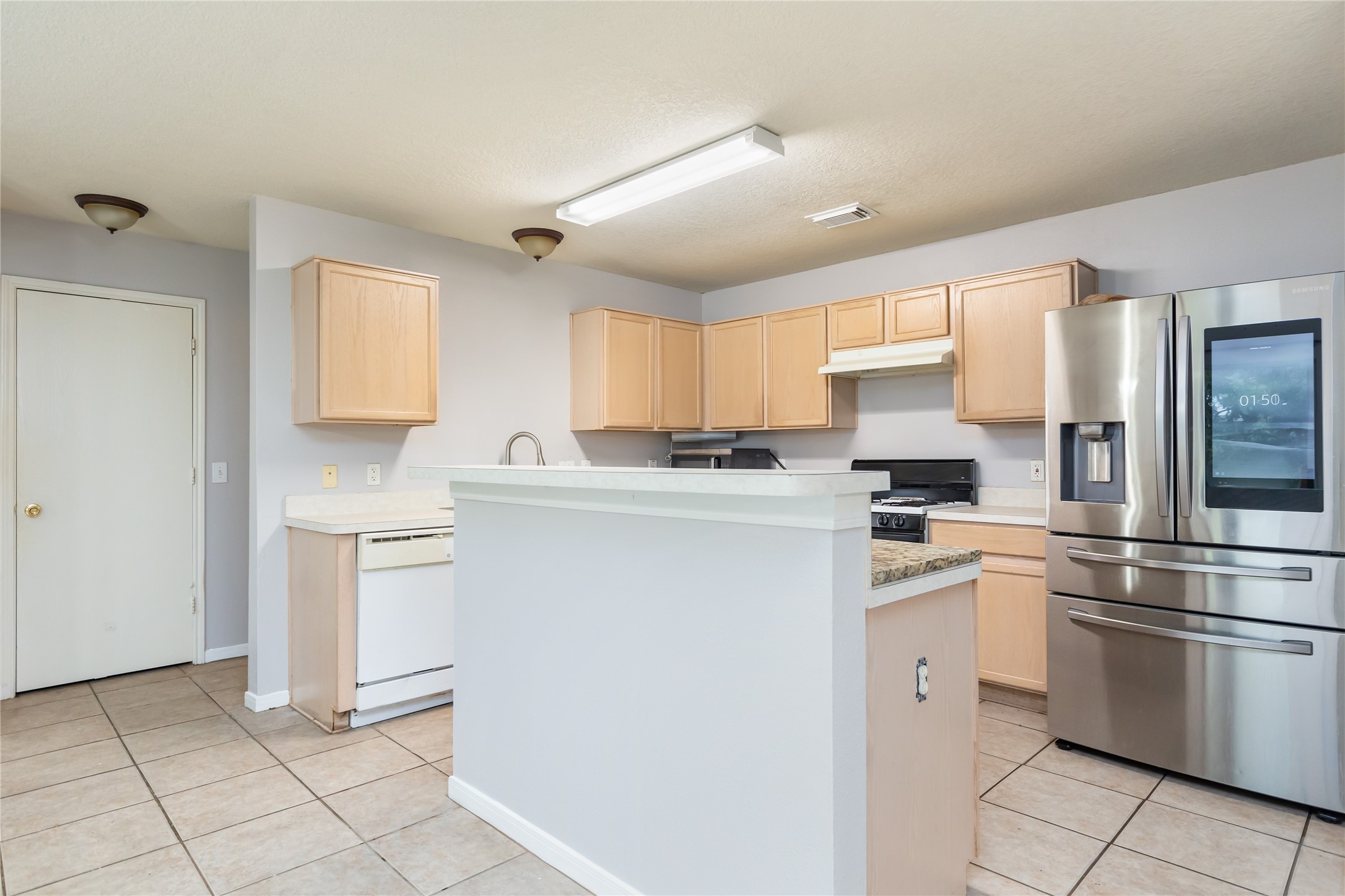 17334 Turquoise Stream Drive Houston, TX 77095 - Photo 7 of 31 a kitchen with white cabinets and white appliances