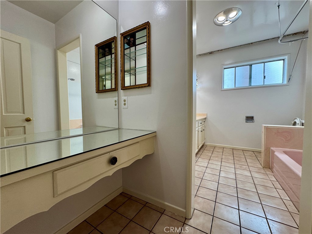 320 North Stoneman Avenue, Unit A Alhambra, CA 91801 - Photo 8 of 14 a bathroom with a sink a toilet and mirror