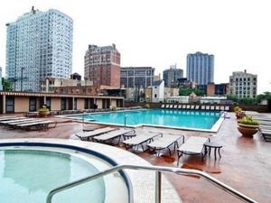 655 West Irving Park Road, Unit 2508 Chicago, IL 60613 - Photo 16 of 20 a view of a swimming pool with outdoor seating and buildings in the background