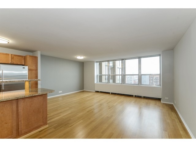 655 West Irving Park Road, Unit 2508 Chicago, IL 60613 - Photo 3 of 20 a view of an empty room with a window and wooden floor