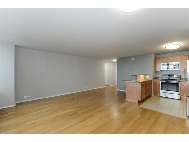 655 West Irving Park Road, Unit 2508 Chicago, IL 60613 - Photo 7 of 20 a view of kitchen and hall with wooden floor
