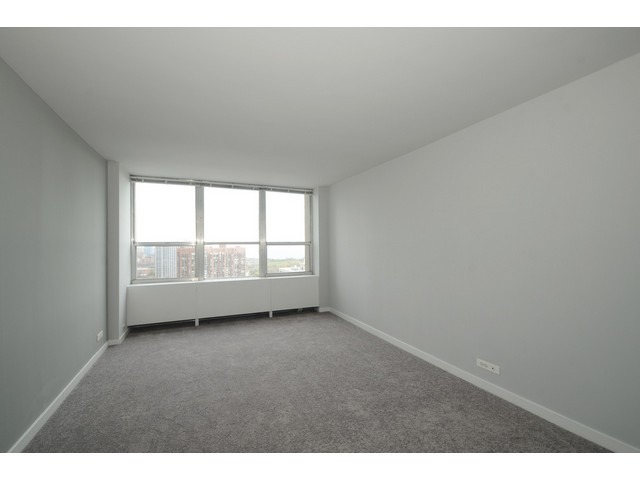 655 West Irving Park Road, Unit 2508 Chicago, IL 60613 - Photo 8 of 20 a view of an empty room with a window