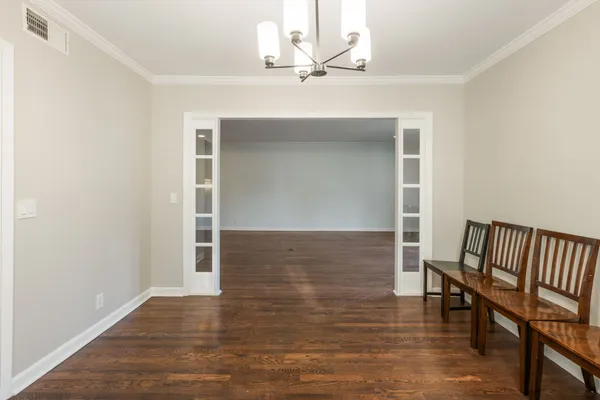a view of a livingroom with wooden floor and staircase