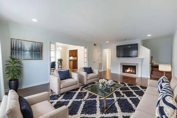 a view of empty room with wooden floor and fireplace