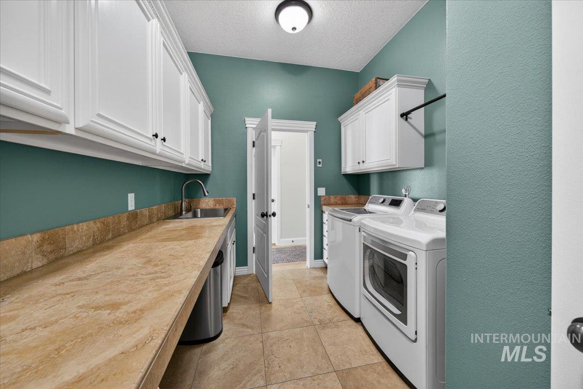 414 East Shafer View Drive Meridian, ID 83642 - Photo 16 of 50 Utility room 11x8 featuring a long countertop, Extra Deep Stainless Steel sink with a gooseneck faucet, ample white storage cabinetry, hanging rod and tile flooring