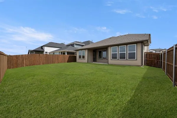 a front view of house with a garden