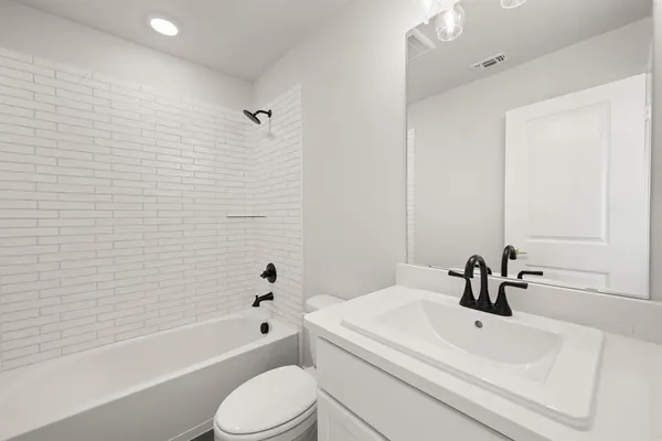 a bathroom with a sink a toilet and a bathtub