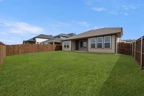 a front view of house with a garden