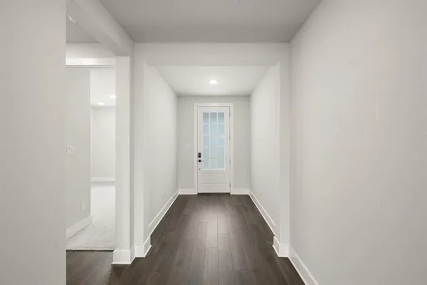 a view of hallway with wooden floor