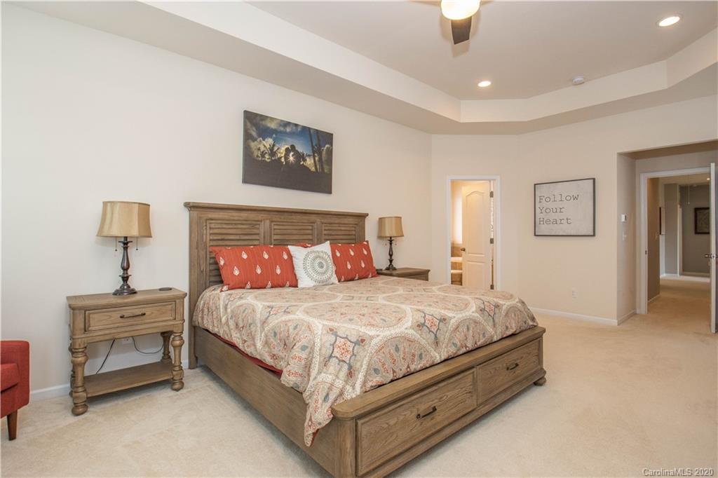 5149 Waterloo Drive Tega Cay, SC 29708 - Photo 13 of 28 a bedroom with a bed and a lamp on table