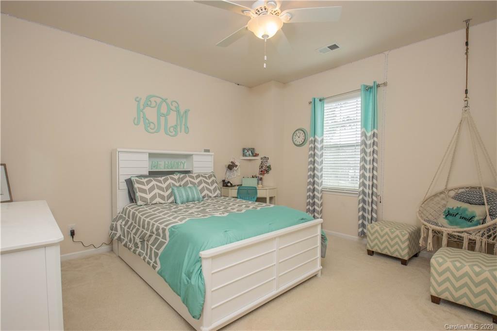 5149 Waterloo Drive Tega Cay, SC 29708 - Photo 20 of 28 a bedroom with a bed and a chandelier