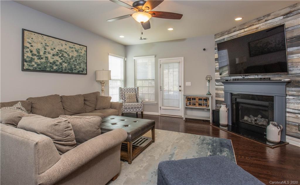 5149 Waterloo Drive Tega Cay, SC 29708 - Photo 3 of 28 a living room with furniture a flat screen tv and a fireplace