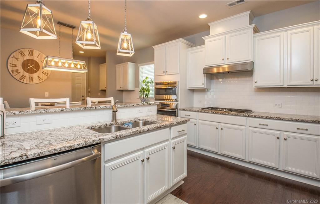 5149 Waterloo Drive Tega Cay, SC 29708 - Photo 6 of 28 a kitchen with stainless steel appliances granite countertop a sink and cabinets