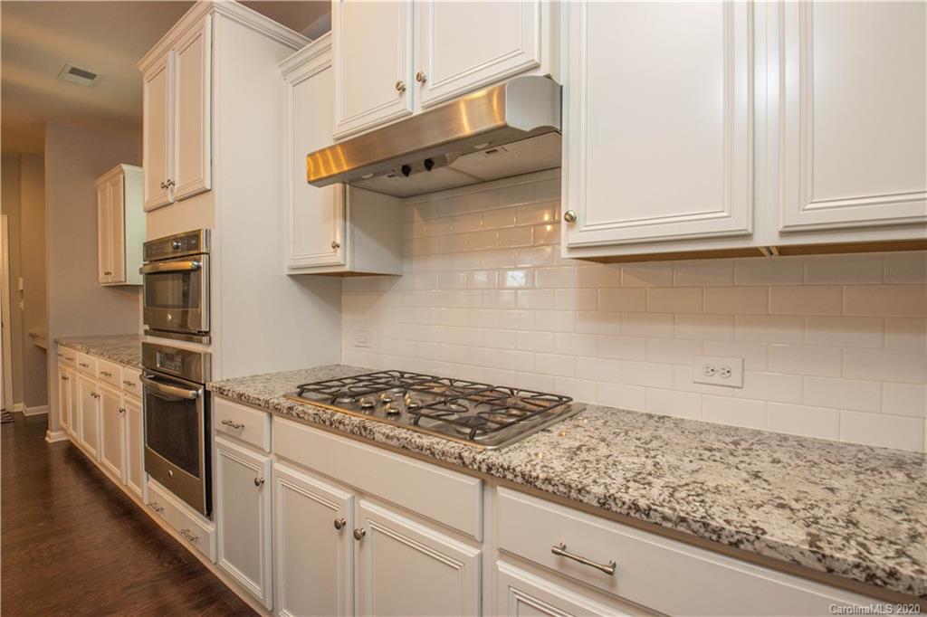 5149 Waterloo Drive Tega Cay, SC 29708 - Photo 7 of 28 a kitchen with white cabinets and appliances