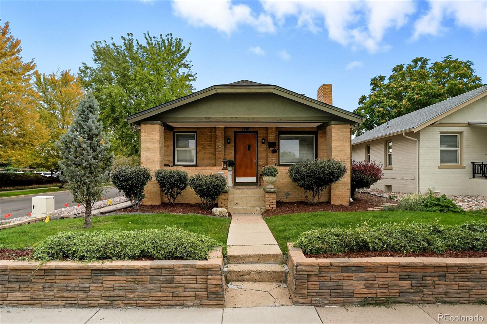 a front view of house with yard and green space