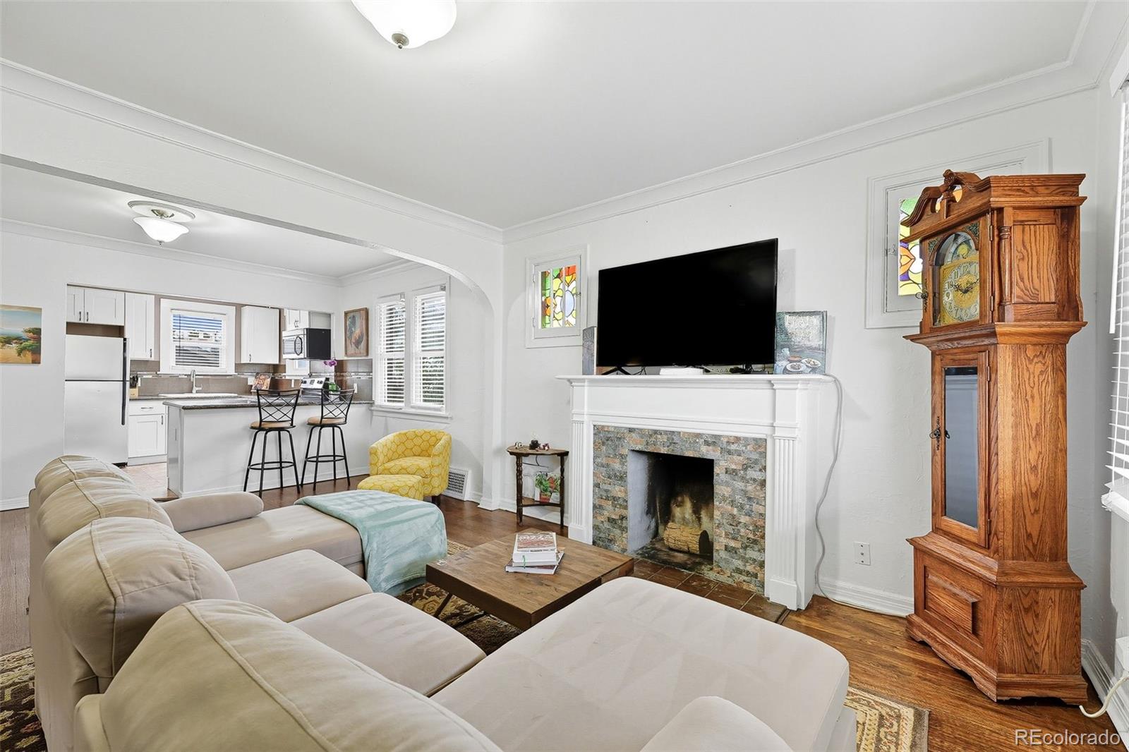 1280 Harrison Street Denver, CO 80206 - Photo 11 of 50 a living room with furniture and a fireplace