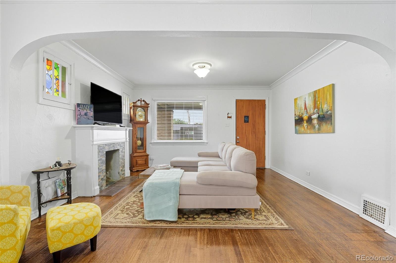 1280 Harrison Street Denver, CO 80206 - Photo 14 of 50 a living room with fireplace furniture and a flat screen tv