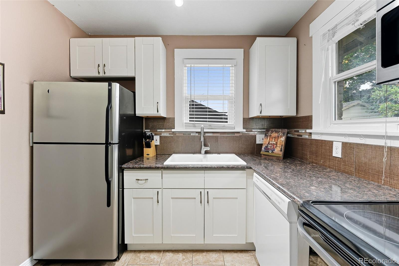 1280 Harrison Street Denver, CO 80206 - Photo 21 of 50 a kitchen with appliances cabinets and a counter space