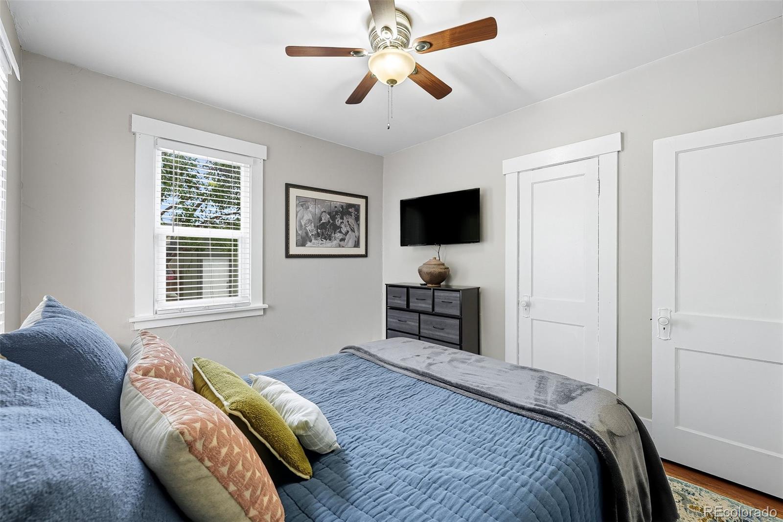 1280 Harrison Street Denver, CO 80206 - Photo 25 of 50 a bedroom with a bed and a flat screen tv