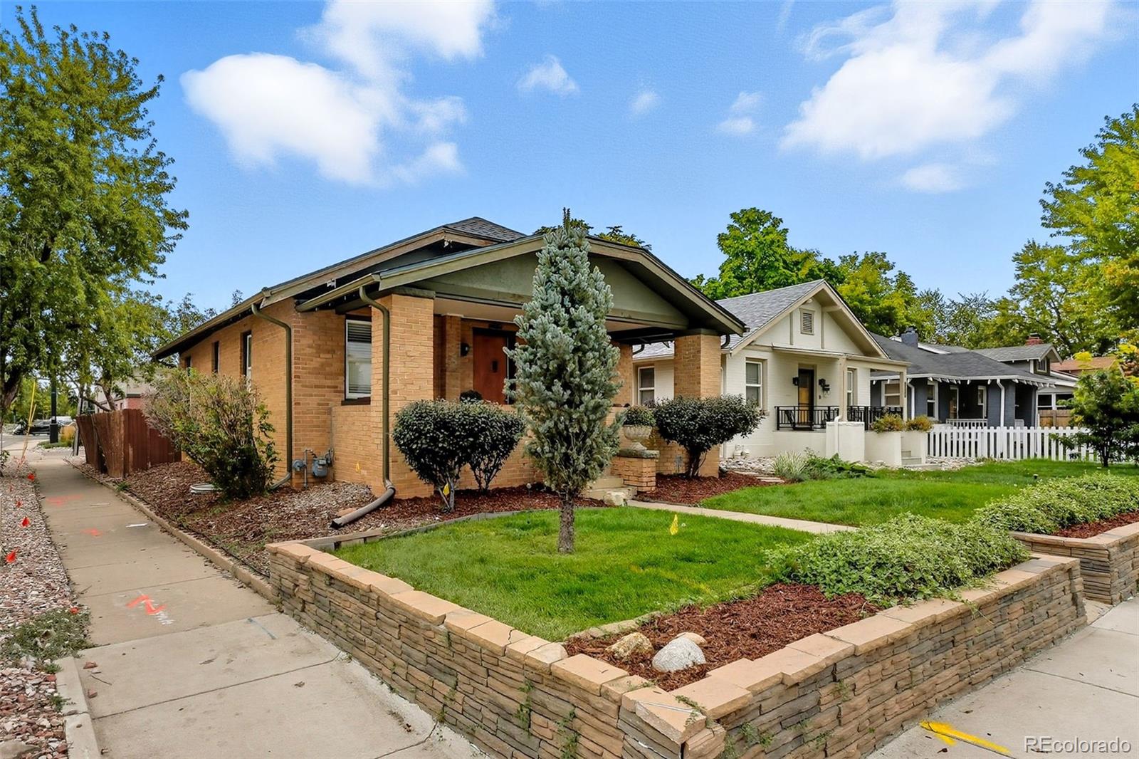 1280 Harrison Street Denver, CO 80206 - Photo 3 of 50 a front view of a house with a yard