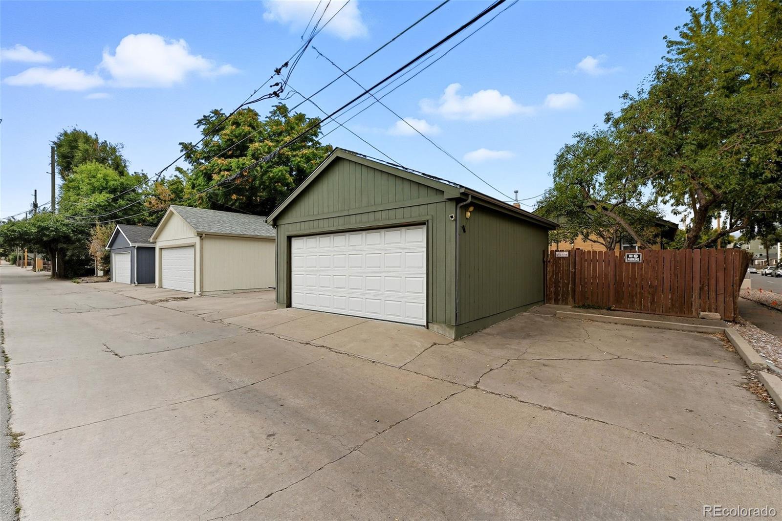 1280 Harrison Street Denver, CO 80206 - Photo 42 of 50 a front view of a house with a yard and garage