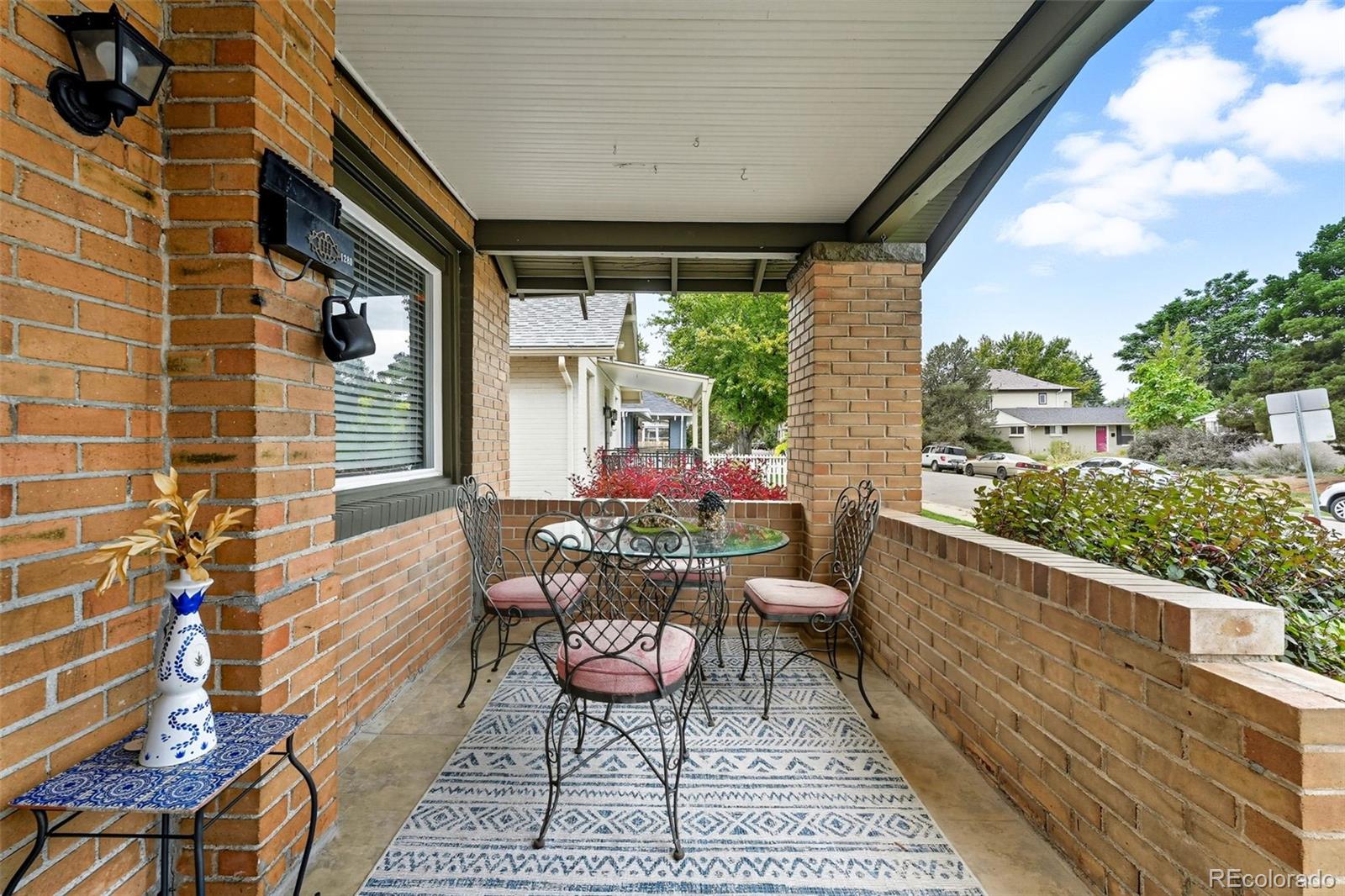 1280 Harrison Street Denver, CO 80206 - Photo 6 of 50 a view of a patio with a dining table and chairs with wooden floor