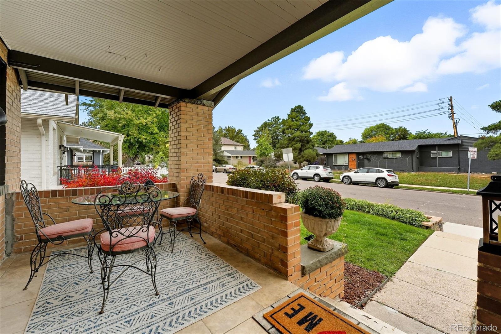 1280 Harrison Street Denver, CO 80206 - Photo 7 of 50 a view of a patio with table and chairs potted plants with wooden floor and fence